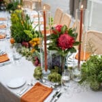 Gala style table runner made from seasonal vegetables and tall pillar candles at The Caylx