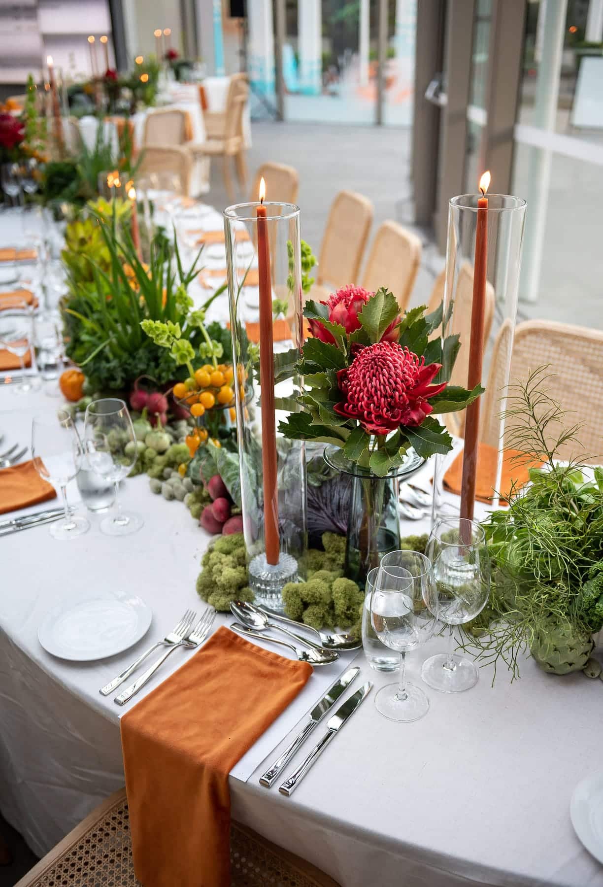 Gala style table runner made from seasonal vegetables and tall pillar candles at The Caylx Gala style table runner made from seasonal vegetables and tall pillar candles at The Caylx
