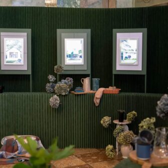 Art gallery nook styled with home decor and hydrangea flowers.